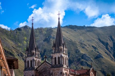 COVADONGA, İspanya - 6 Nisan 2025: Asturias 'taki Covadonga kutsal mağarası, bazilikası ve çarpıcı doğal çevresiyle bilinen tarihi bir dağ köyüdür..