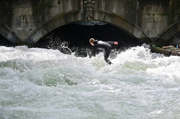 stock image The Eisbachwelle is an artificial standing wave in the Eisbach of the English Garden that is ideal for surfing all year round.