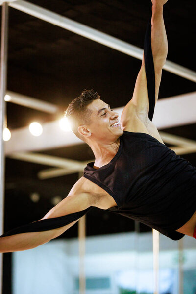 With each twist of the silk, the acrobat creates a spellbinding tapestry of movement, transforming the performance space into a breathtaking aerial canvas