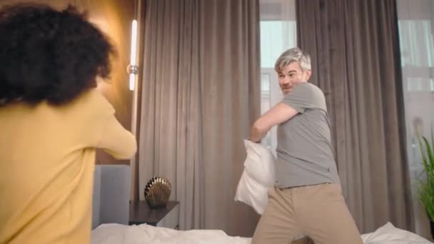 Attractive African American Wife Caucasian Husband Having Pillow Fight Going — Stock Video