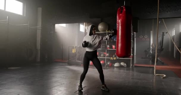 可敬的白种人女强人使用拳击手套 在拳击馆进行练习 迷人的女性 肌肉发达 拳打脚踢袋 准备战斗 专业培训的概念 — 图库视频影像