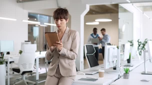 Hardworking Caucasian Woman Sitting Desk Computers Using Tablet Device Browsing — Stock Video