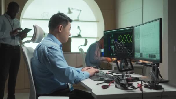Side View Asian Engineer Programming Software Robots Hardworking Man Typing — Stock Video