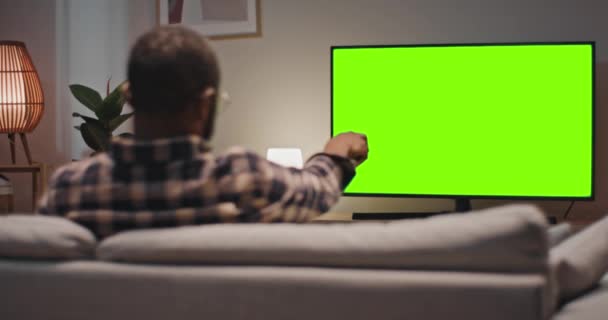 Man Sitting Sofa Enjoying Favourite Show Back View Male Holding — Stock Video
