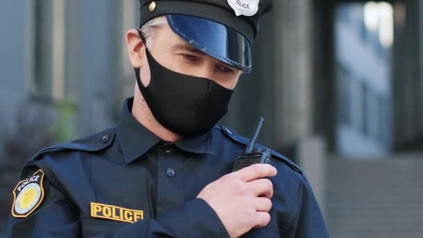 옥외에 경찰복을 잘생긴 성숙한 워키토키에서 연설하는 집행기관 대표요 경찰관의 의사소통이요 — 비디오