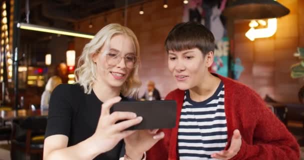 Hezká Běloška Blonďatými Vlasy Brýlemi Držící Smartphone Zatímco Něco Ukazuje — Stock video