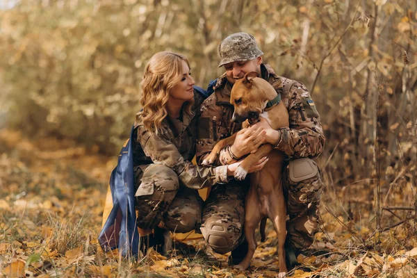 A Ukrainian military couple meet their dog and play with him.