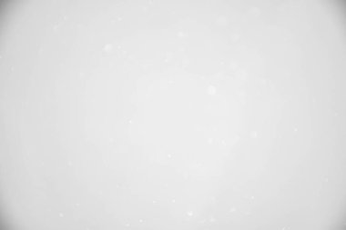 Koyu arkaplanda beyaz bokeh.