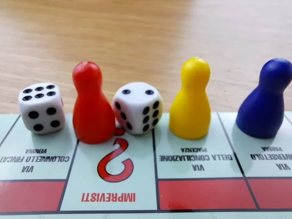 Board Game Pawns And Dice With Colored Pieces. Italian Monopoly game.