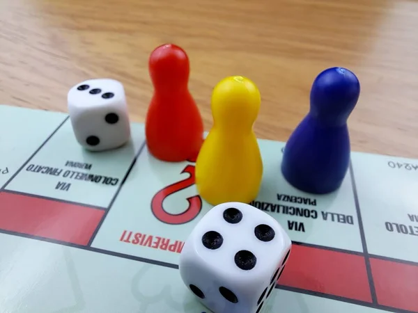 Board Game Pawns And Dice With Colored Pieces. Italian Monopoly game.