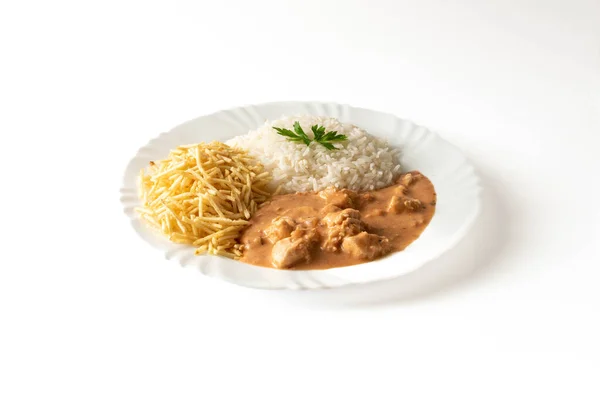 stock image Chicken stroganoff accompanied with rice and potato straw.