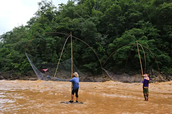 stock image Fishermen using netting equipment (square dip net) in catching fish at Kaeng Luang, Nan Province, Thailand 