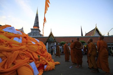 Nakhon Si Thammarat, Thailand - Feb 18 2011: Hae Pha Khuen That Festival (Festival fabric element) is celebrated at Phra Borom That Chedi (Pagoda). Buddhists bring cloth to wrap around the pagoda  clipart