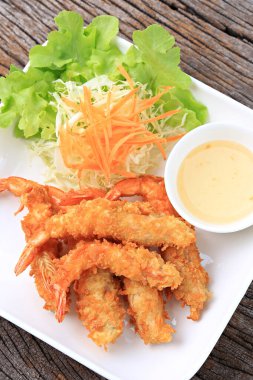 Crispy Batter Fried Prawns garnished with shredded cabbage and carrots, Food photography for use in menus 