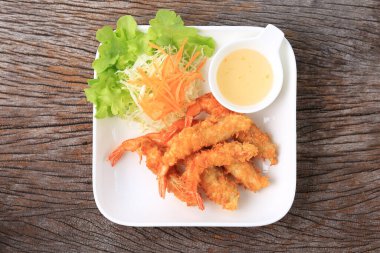 Crispy Batter Fried Prawns garnished with shredded cabbage and carrots, Food photography for use in menus 