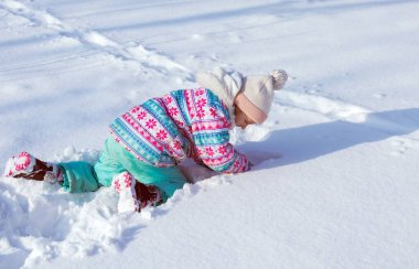 7-9 yaşlarında bir kız, karda oynar, kışın karla kaplı bir şehir manzarası, çok kar, sokakta oynayan bir çocuk