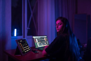 Geceleri evde çalışan çekici genç bir kadın. Dizüstü bilgisayar kullanan kız.