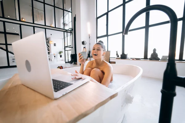 Young Woman Working Laptop While Taking Bathtub Home — Stok fotoğraf