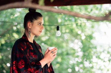 Çay fincanından içen bir kadın resmi, yakın görüş.