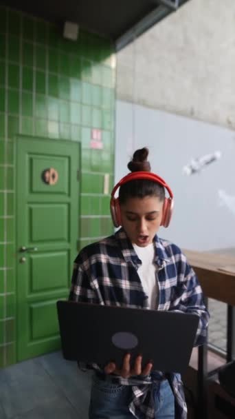 Beautiful Girl Headphones Talking Typing Laptop Cafe High Quality Fullhd — Stock Video