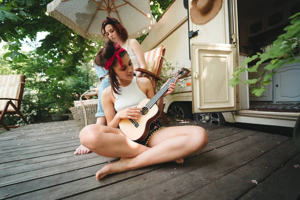 stock image Happy hippie friends are having a good time together in camper trailer. Holiday, vacation, trip concept. High quality photo