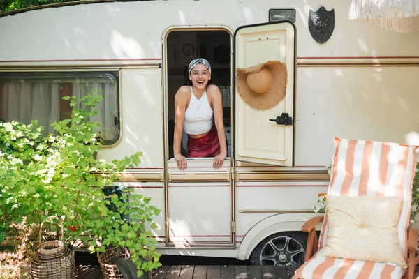 stock image Happy hippie girl are having a good time in a camper trailer. Holiday, vacation, trip concept.High quality photo