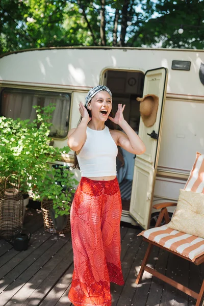 stock image Happy hippie girl are having a good time in a camper trailer. Holiday, vacation, trip concept.High quality photo