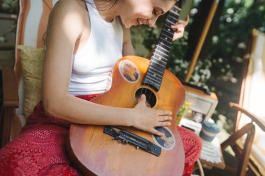 Mutlu hippi kız karavanda gitar çalarak iyi vakit geçiriyor. Tatil, tatil, gezi konsepti. Yüksek kalite fotoğraf.