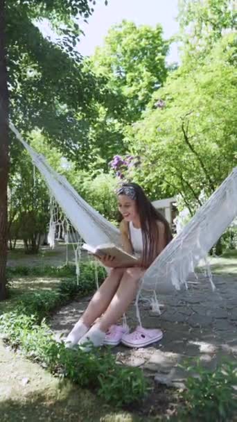 Beautiful Hippie Girl Sitting Hammock Summer Day Reading Book High — Stockvideo
