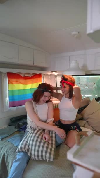 Two Beautiful Hippie Girls Laughing Hugging Bed Trailer Lgbt Flag — Stok video