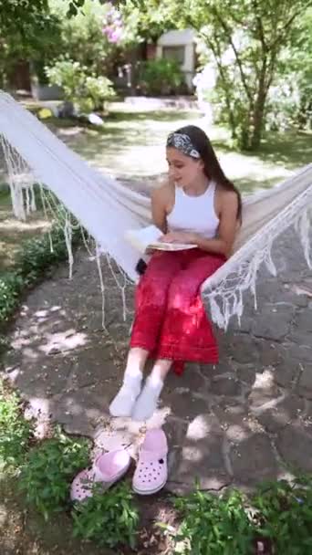 Beautiful Hippie Girl Swinging Hammock Flipping Book High Quality Footage — Video