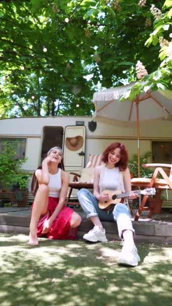 Two Beautiful Hippie Girls Singing Song Sitting Terrace Trailer Guitar — стоковое видео
