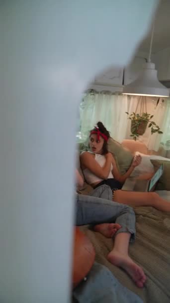 Two Hippie Girls Relaxing Trailer Laptop Gaze Out Back Window — Stockvideo