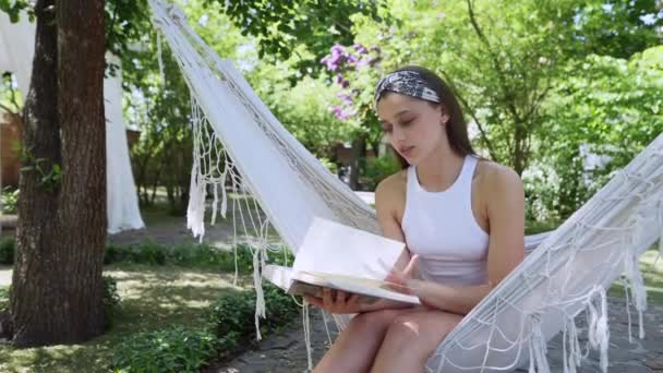Beautiful Hippie Girl Sitting Hammock Summer Day Reading Book High — стоковое видео