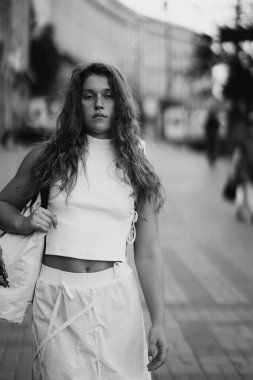 monochromatic image of a trendy young girl with curly hair. High quality photo