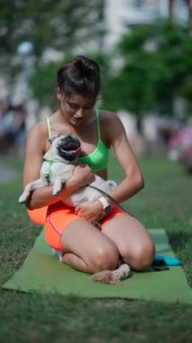 Parktaki sabah antrenmanı sırasında spor giyim sektöründe güzel bir kız köpeğiyle oyun oynamaktan zevk alıyor. Yüksek kalite 4k görüntü