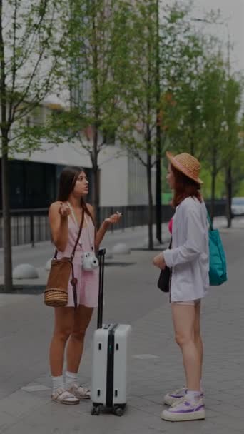 Two Beautiful Youthful Girls Each Carrying Bags Suitcase Chatting City — Stock Video