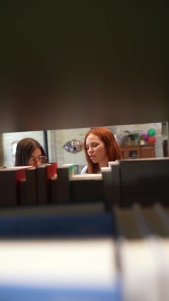 Twee Charmante Jonge Vrouwen Praten Bibliotheek Hoge Kwaliteit Beeldmateriaal — Stockvideo