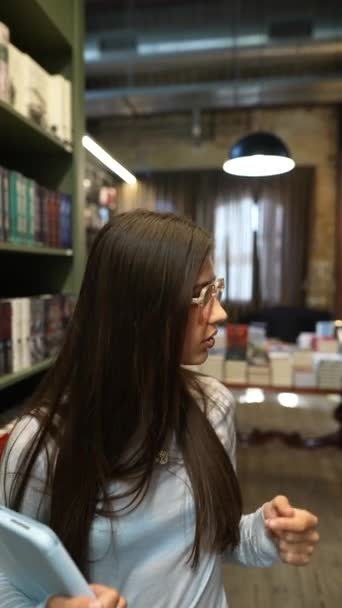 Табличкой Руках Милая Юная Леди Обсуждает Книжный Магазин Высококачественные Кадры — стоковое видео