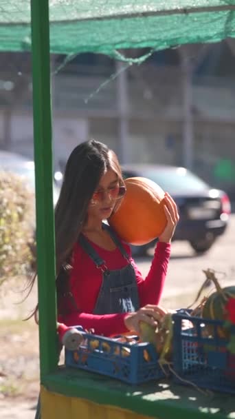 Young Female Farmer Showcasing Large Orange Pumpkin She Selling Market — Stock Video