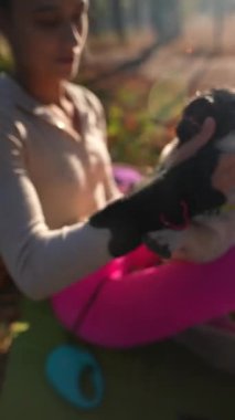 Sonbahar manzarasının ortasında, keyifli genç bir kadın ve köpeği sevgi dolu bir kucaklaşmayı paylaşıyor. Yüksek kalite 4k görüntü