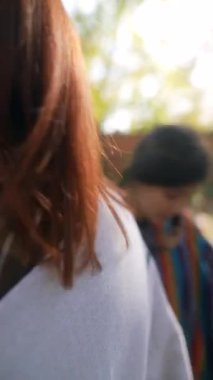 Sonbahar ışınlarının ortasında, hippi kıyafetleriyle iki arkadaş güneşin tadını çıkarıyor. Yüksek kalite 4k görüntü