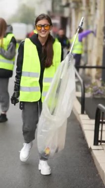 Kamu alanı temizliği: kadın işçi özel maşa kullanarak çöp topluyor. Yüksek kalite 4k görüntü