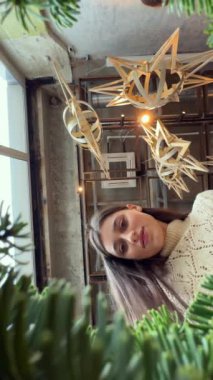 Aşağıdan bakıldığında, Yeni Yıl dekoru ve Noel çelengi oluşturulduğunu belgelemek. Yüksek kalite 4k görüntü