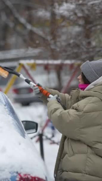 Young Woman Clears Snow Her Car Using Brush City Street — Stock Video