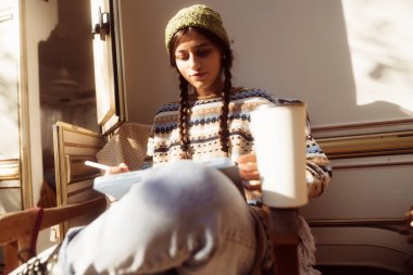 Havalı bir bayan, hippi kişiliğini parkın doğal güzelliğine karşı kucaklıyor, yanında da bir karavanı var. Yüksek kalite fotoğraf