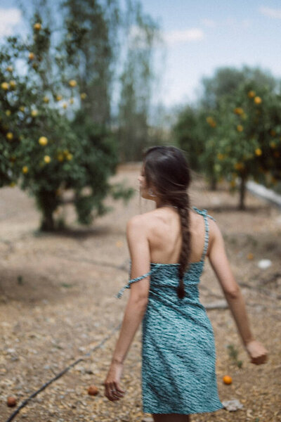 Serene Woman Green Dress Braid Peacefully Walking Fruit Tree Plantation Stock Image