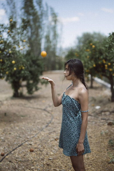 Woman Summer Dress Juggles Orange Lush Orchard Embodying Joy Carefreeness Stock Image