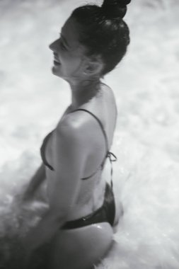 Genç bir kadın kendini suda mutlu bir anın tadını çıkarırken bulur. Saf mutluluk ve sükunet yayar.