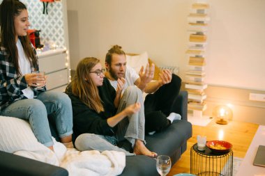 Friends gather for a cozy movie night at home, creating a warm atmosphere filled with laughter and good vibes clipart